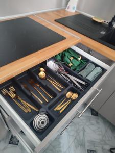 a drawer in a kitchen filled with cooking utensils at Studio Zen Miramas in Miramas