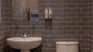 a bathroom with a sink and a toilet at Burrator Inn in Yelverton