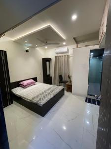 a bedroom with a bed in a room at Myra Villa Kolhapur Entire Private Home in Kolhapur
