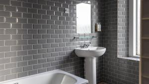 a bathroom with a white sink and a mirror at Burrator Inn in Yelverton