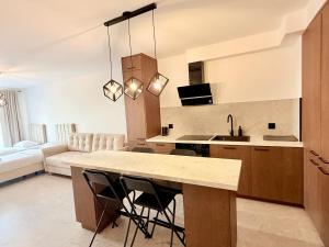 a kitchen with a table and chairs in a room at Drahan Apartment 38 in Radom
