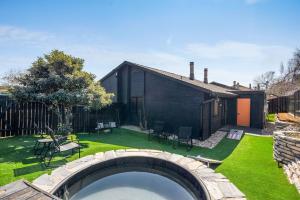 a backyard with a swimming pool and a house at The Orange Door - Two Homes - Plunge Pool in Austin
