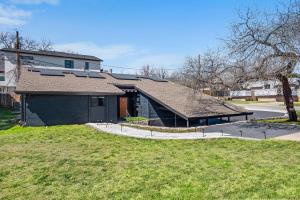 a house with a roof on top of a yard at The Orange Door - Two Homes - Plunge Pool in Austin
