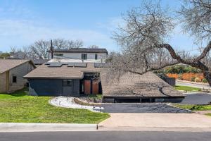 a house with a large roof and a driveway at The Orange Door - Two Homes - Plunge Pool in Austin