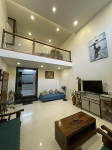 a large living room with a couch and a tv at Myra Villa Kolhapur Entire Private Home in Kolhapur
