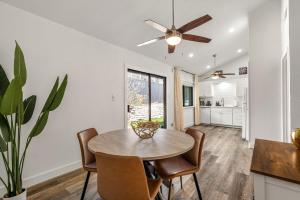 a dining room with a table and chairs and a ceiling fan at The Orange Door - Unit A - Heated Plunge Pool in Austin