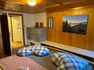 a bedroom with two beds and a picture on the wall at Ferienhaus Gertrud in Nesselwängle