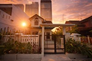 a white house with a gate and a fence at Yokohama Premium House in Batam Center