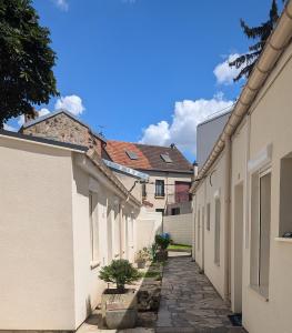 a row of white buildings with a pathway between them at *Ça me convient* Studio Chaleureux in Villejuif