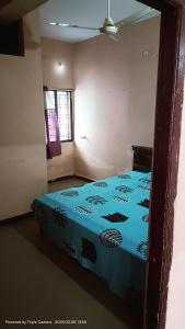 a bedroom with a blue bed in a room at Durga Nivas in Kurnool