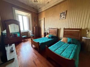 a living room with two beds and a tv at B&B Falconi in Fermo