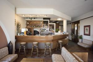 a bar in a restaurant with stools at Hotel Gigliola in Bellaria-Igea Marina