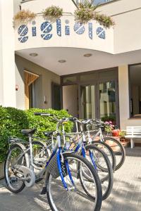 a row of bikes parked in front of a building at Hotel Gigliola in Bellaria-Igea Marina