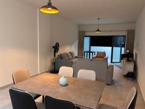 a dining room and living room with a table and chairs at Sky Garden Appartement in Quatre Bornes