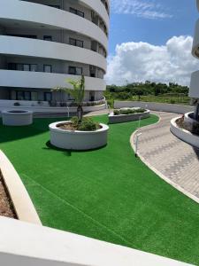 a building with green grass in front of a building at Sky Garden Appartement in Quatre Bornes