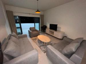 a living room with a couch and a table at Sky Garden Appartement in Quatre Bornes