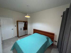 a bedroom with a blue bed and a mirror at Sky Garden Appartement in Quatre Bornes +9 photos
