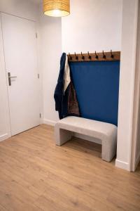 a bench sitting in a room with a blue wall at L'entracte in Clairvaux-les-Lacs