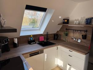 a kitchen with a sink and a window at Seequartier Borken in Borken