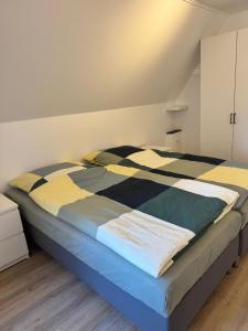 a bedroom with a bed with a striped comforter at Seequartier Borken in Borken