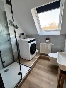 a bathroom with a shower and a toilet and a window at Seequartier Borken in Borken +33 photos