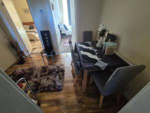 a dining room with a long table and chairs at Cosy and Bright 3-bedroom flat in Glasgow