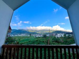 a view of a city from a balcony at Glamping Calla in Banjarnegara