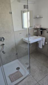 a bathroom with a shower and a sink at Gästehaus König in Weinstadt +19 photos