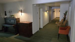 a corridor of a room with a hallway with a table and chairs at Gästehaus König in Weinstadt