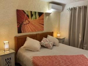 a bedroom with a bed with two pillows on it at Fantastic spacious beachfront VILLAVACANCES in Grand-Baie