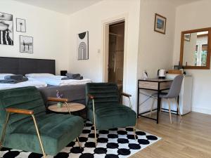 a bedroom with a bed and a table and chairs at Pension Kitty in Pörtschach am Wörthersee