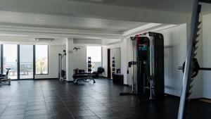 a room with a gym with tread machines in it at Pulsera Beach Residence Maldives by Circles Hospitality in Hulhumale
