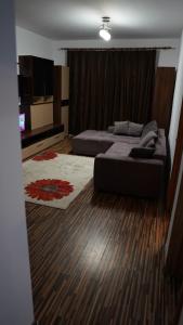 a bedroom with two beds and a flat screen tv at Apartament 2 camere SIBIU-SELIMBAR in Şelimbăr