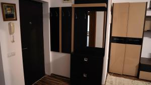 a black closet with a mirror and a phone at Apartament 2 camere SIBIU-SELIMBAR in Şelimbăr