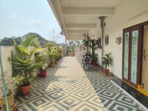 a corridor of a building with plants on the floor at SRI PADMAVATHI NiVAS in Pithāpuram