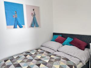 a bedroom with a bed and pictures on the wall at Sunset Studio in Kwidzyn