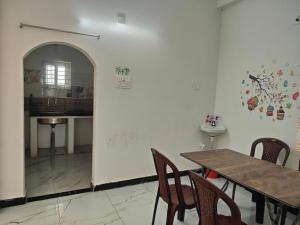 a dining room with a table and chairs at SRI PADMAVATHI NiVAS in Pithāpuram