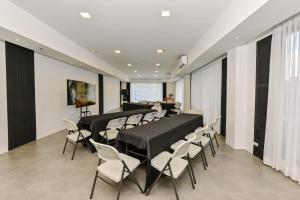 a waiting room with chairs and tables in a building at Casa Charlie Hotel in Manila
