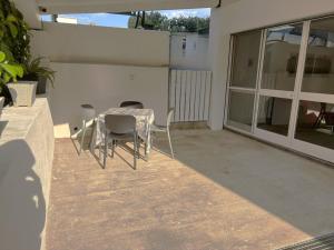 a table and chairs sitting on a patio at Home Sicilia in Carini