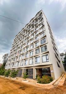 a large white building with many windows at SympaHome in Kiambu