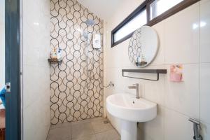 a bathroom with a sink and a mirror at NO 7 Garden Villa in Rawai Beach
