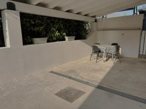 a patio with a table and chairs on a roof at Home Sicilia in Carini +6 photos