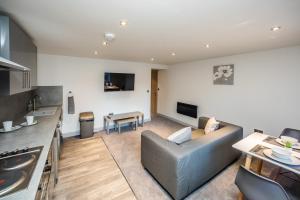 a living room with a couch and a table at Edgerton Stays in Huddersfield