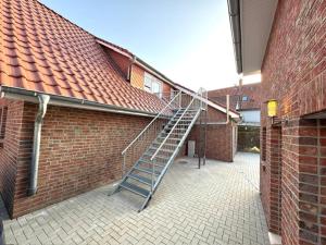 a metal staircase in the side of a brick building at Apartments Rosenstraße in Soltau