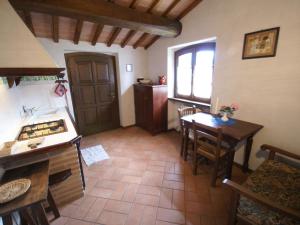a kitchen with a stove and a table and a window at Holiday Home in Montone with Pool & Terrace in Montone +9 photos
