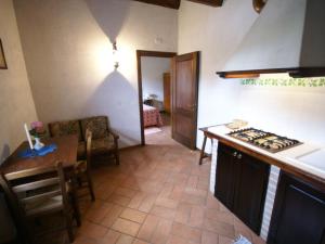 a kitchen with a table and a stove top oven at Holiday Home in Montone with Pool & Terrace in Montone