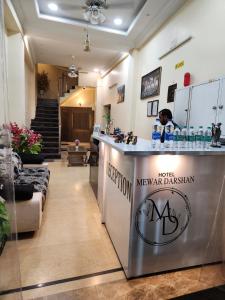 a hotel mexican restaurant with a counter in a lobby at New Mewar Darshan in Udaipur