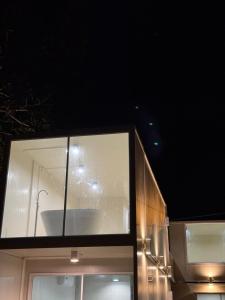 a glass building with a tub on top of it at Sand Bara in Ban Pak Ba Ra