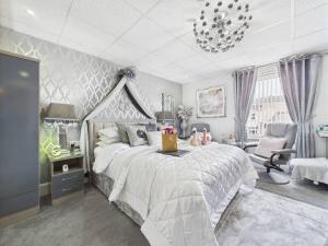 a bedroom with a large bed and a chandelier at Sorrento House in Blackpool