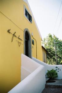a yellow building with writing on the side of it at The Five House in Sintra